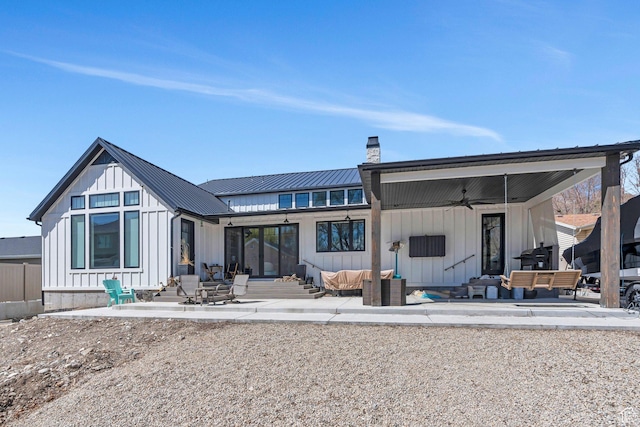654 N 200 E, American Fork, UT 84003 - rear view of house featuring board and batten siding, ceiling fan, a chimney, a patio area, and an outdoor hangout area