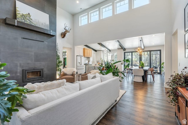 654 N 200 E, American Fork, UT 84003 - living room with a high ceiling, a chandelier, dark wood-style floors, and a tiled fireplace