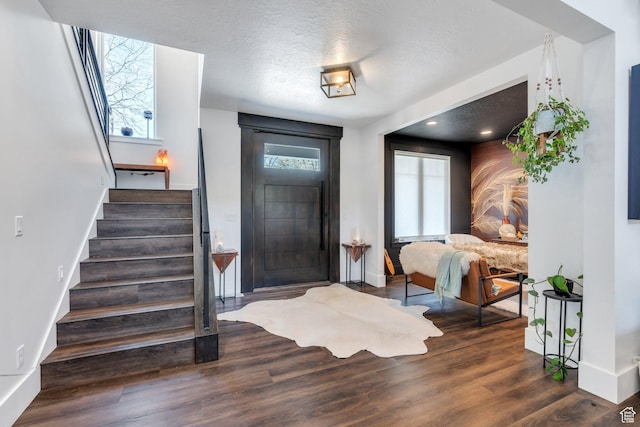 654 N 200 E, American Fork, UT 84003 - foyer entrance with a textured ceiling, baseboards, wood finished floors, and stairway