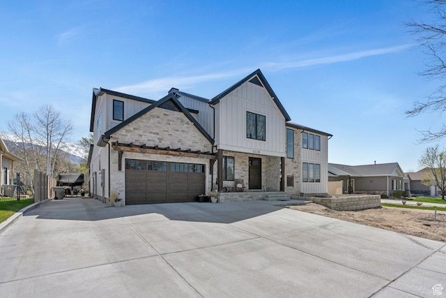 654 N 200 E, American Fork, UT 84003 - modern farmhouse style home with board and batten siding, an attached garage, concrete driveway, and stone siding