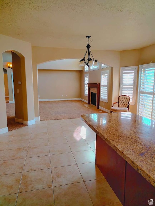 3641 W Canyon Lands Dr, Riverton, UT 84065 - interior space featuring arched walkways, a textured ceiling, light tile patterned floors, and a wealth of natural light