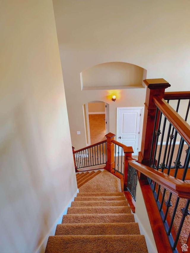 3641 W Canyon Lands Dr, Riverton, UT 84065 - stairway featuring arched walkways and baseboards