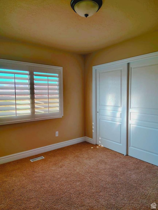 3641 W Canyon Lands Dr, Riverton, UT 84065 - unfurnished bedroom featuring baseboards, carpet, a closet, and visible vents