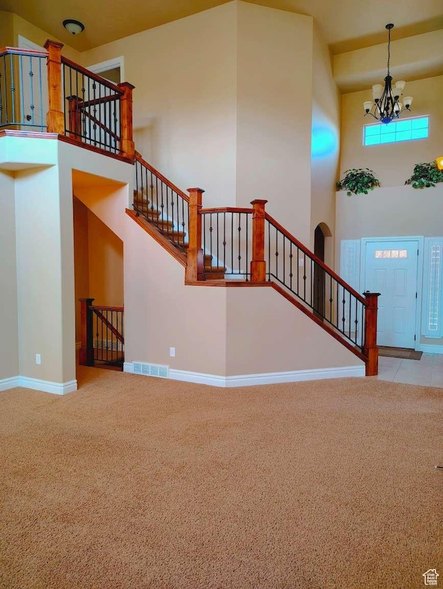 3641 W Canyon Lands Dr, Riverton, UT 84065 - stairway with a high ceiling, an inviting chandelier, carpet, baseboards, and visible vents