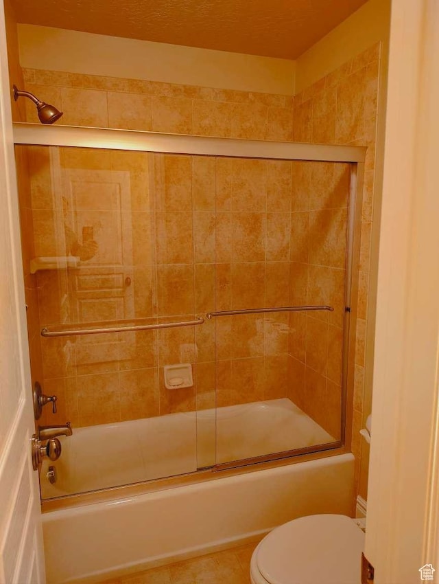 3641 W Canyon Lands Dr, Riverton, UT 84065 - bathroom with tile patterned flooring, enclosed tub / shower combo, and toilet