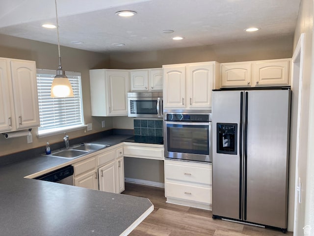 1409 S 30 E, Payson, UT 84651 - kitchen with a sink, appliances with stainless steel finishes, dark countertops, and white cabinetry