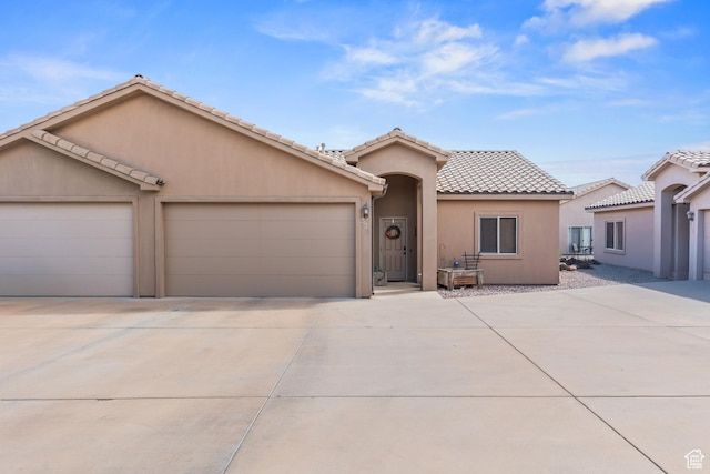502 N 2480 W, Hurricane, UT 84737 - ranch-style home with concrete driveway, stucco siding, a tile roof, and a garage