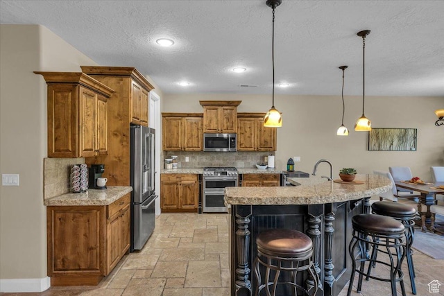 305 E 350 N, Ivins, UT 84738 - kitchen featuring a breakfast bar area, brown cabinetry, stainless steel appliances, tasteful backsplash, and stone tile flooring