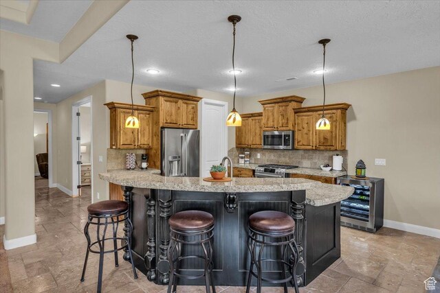 305 E 350 N, Ivins, UT 84738 - kitchen with brown cabinets, beverage cooler, baseboards, and appliances with stainless steel finishes