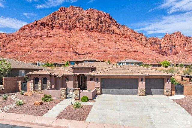 305 E 350 N, Ivins, UT 84738 - view of front of property featuring stucco siding, a gate, a mountain view, and stone siding