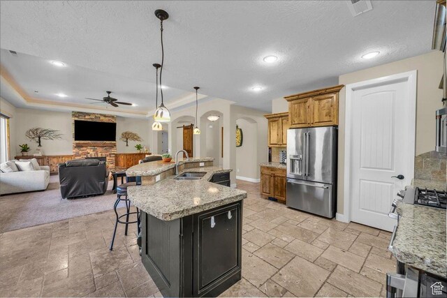 305 E 350 N, Ivins, UT 84738 - kitchen featuring high end fridge, arched walkways, a sink, and stone tile flooring