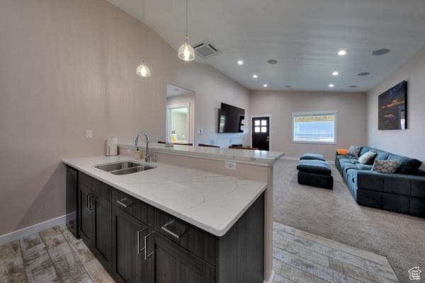 17 Tangren Cir, Moab, UT 84532 - kitchen featuring a peninsula, open floor plan, visible vents, and a sink