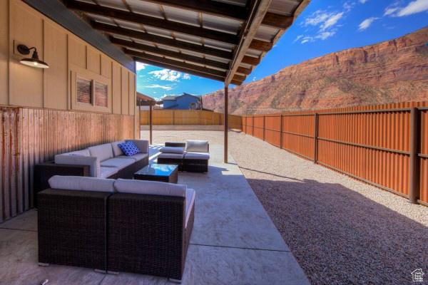 17 Tangren Cir, Moab, UT 84532 - view of patio featuring a mountain view, an outdoor hangout area, and a fenced backyard