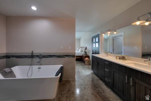 17 Tangren Cir, Moab, UT 84532 - full bathroom with double vanity, a freestanding tub, speckled floor, a sink, and ensuite bath