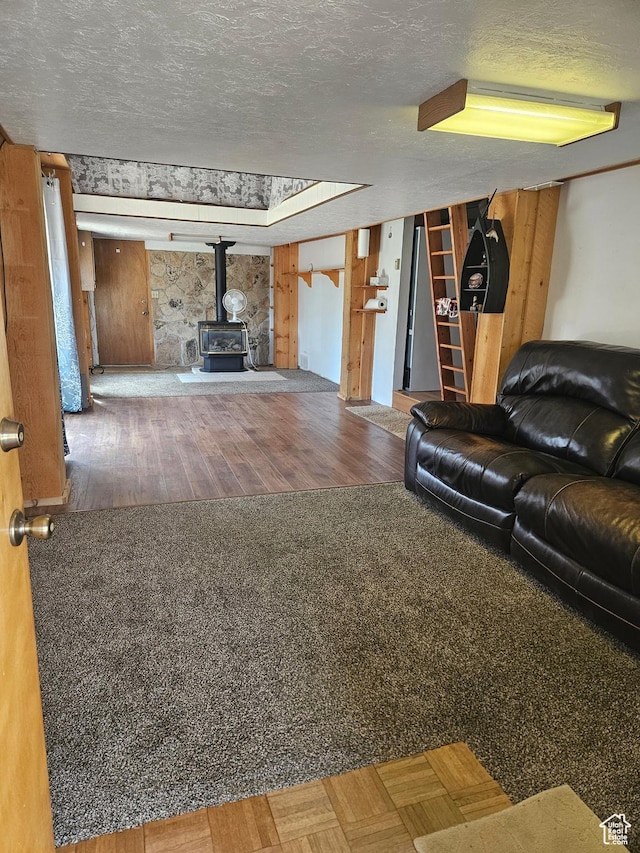 33383 W 8000 S, Duchesne, UT 84021 - living room featuring a wood stove, wood finished floors, and a textured ceiling