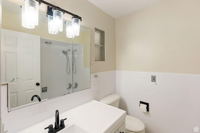 163 E 350 S, Logan, UT 84321 - full bathroom with vanity, toilet, tile walls, bathtub / shower combination, and a wainscoted wall