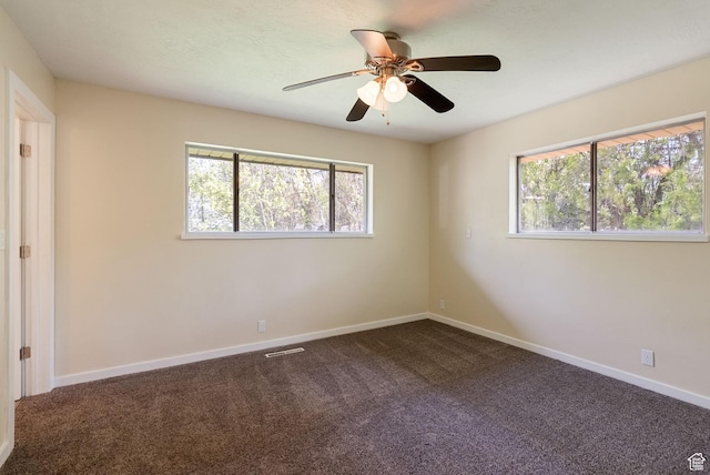 163 E 350 S, Logan, UT 84321 - unfurnished bedroom featuring dark carpet, baseboards, ceiling fan, and multiple windows