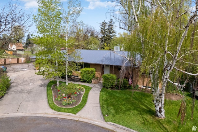 163 E 350 S, Logan, UT 84321 - single story home with brick siding, concrete driveway, metal roof, and a front yard