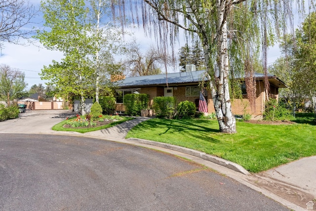 163 E 350 S, Logan, UT 84321 - ranch-style home featuring brick siding, a front yard, and aphalt driveway