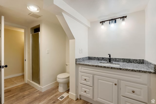 163 E 350 S, Logan, UT 84321 - bathroom featuring visible vents, a stall shower, toilet, and wood finished floors