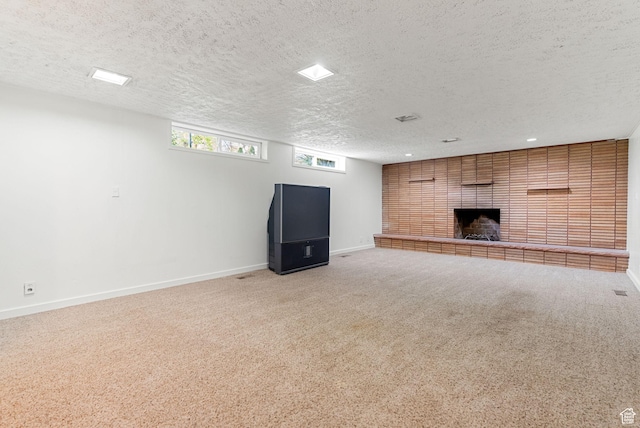 163 E 350 S, Logan, UT 84321 - unfurnished living room with baseboards, carpet flooring, a textured ceiling, and a brick fireplace