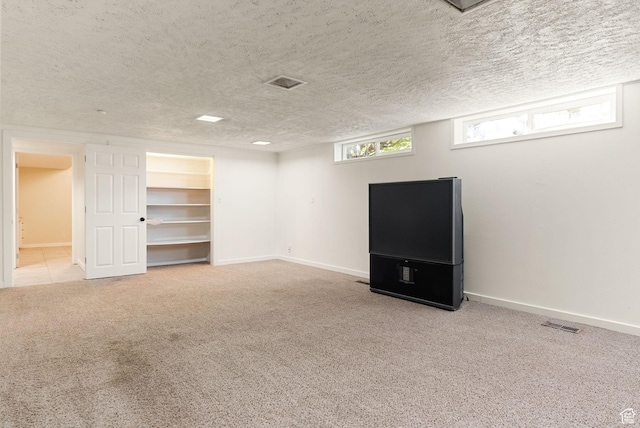 163 E 350 S, Logan, UT 84321 - below grade area featuring carpet floors, a textured ceiling, baseboards, and visible vents