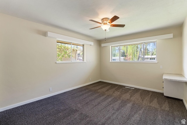163 E 350 S, Logan, UT 84321 - spare room with dark colored carpet, baseboards, ceiling fan, and visible vents