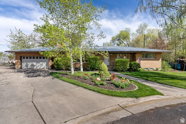 163 E 350 S, Logan, UT 84321 - single story home with a front lawn, brick siding, metal roof, an attached garage, and driveway