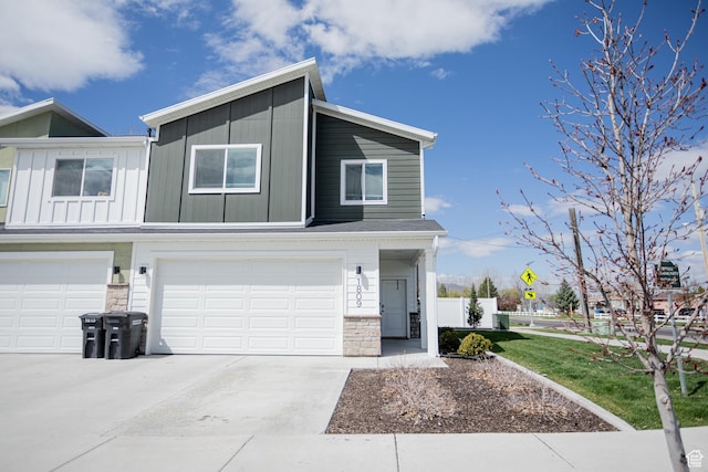 1809 S 1280 W, Logan, UT 84321 - view of front facade featuring a garage, fence, stone siding, board and batten siding, and driveway