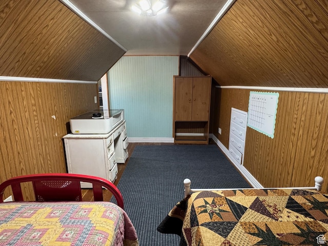 bedroom with carpet flooring, baseboards, wood walls, and vaulted ceiling