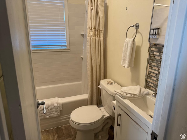 bathroom with shower / bath combo with shower curtain, wood finished floors, toilet, and vanity