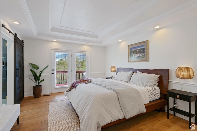 4356 W Elk Rim Rd, South Jordan, UT 84009 - bedroom featuring a tray ceiling, a barn door, access to exterior, ornamental molding, and light wood-style flooring