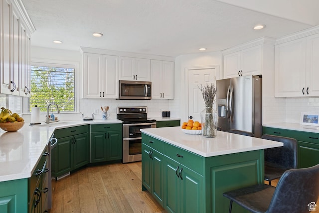 4356 W Elk Rim Rd, South Jordan, UT 84009 - kitchen featuring stainless steel appliances, green cabinets, a sink, white cabinetry, and light wood-style flooring
