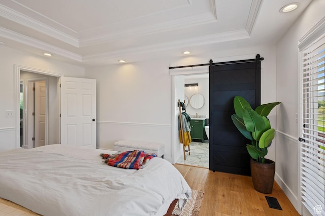 4356 W Elk Rim Rd, South Jordan, UT 84009 - bedroom featuring a raised ceiling, crown molding, a barn door, light wood finished floors, and recessed lighting
