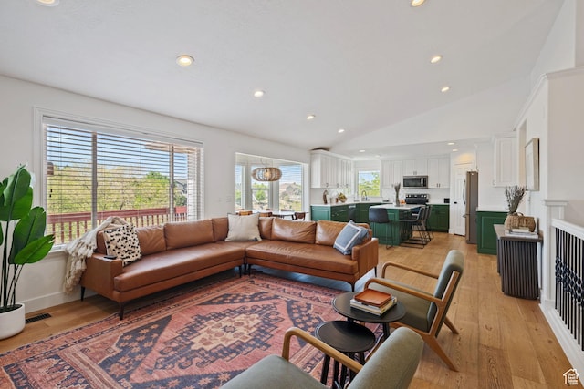 4356 W Elk Rim Rd, South Jordan, UT 84009 - living area with light wood-style floors, vaulted ceiling, and recessed lighting