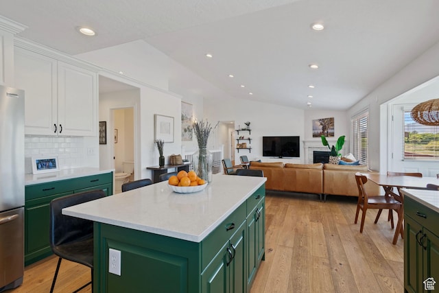 4356 W Elk Rim Rd, South Jordan, UT 84009 - kitchen featuring green cabinets, freestanding refrigerator, white cabinetry, a fireplace, and light wood-type flooring
