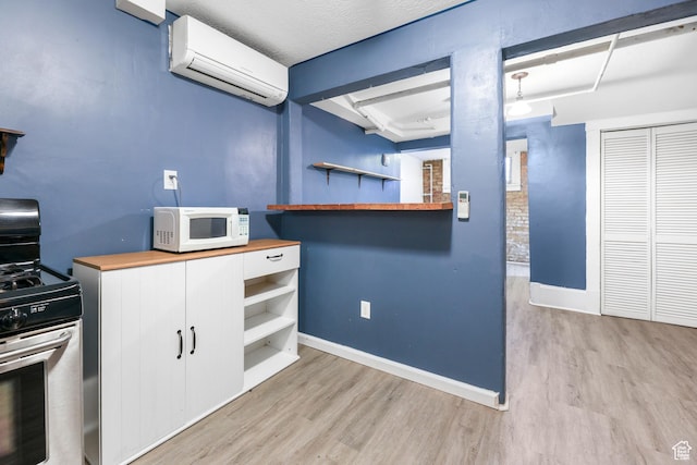 86 N B St Unit 11, Salt Lake City, UT 84103 - kitchen featuring open shelves, butcher block countertops, a wall mounted air conditioner, white microwave, and stainless steel range