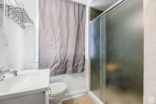 86 N B St Unit 11, Salt Lake City, UT 84103 - full bath featuring vanity, toilet, tile patterned floors, baseboards, and a shower stall