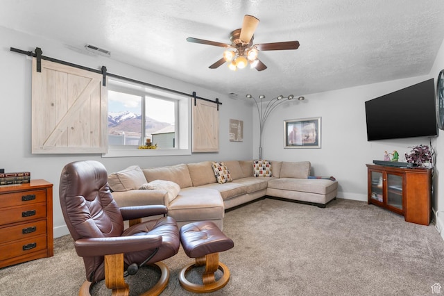 627 S 825 E, Layton, UT 84041 - carpeted living area with visible vents, a barn door, a textured ceiling, and ceiling fan