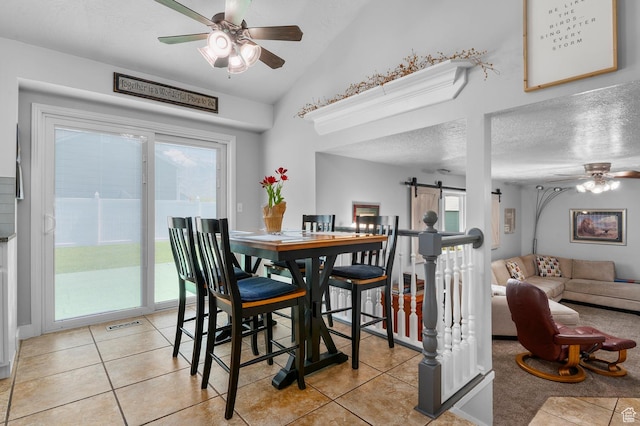 627 S 825 E, Layton, UT 84041 - dining room with a barn door, a textured ceiling, ceiling fan, and light tile patterned floors