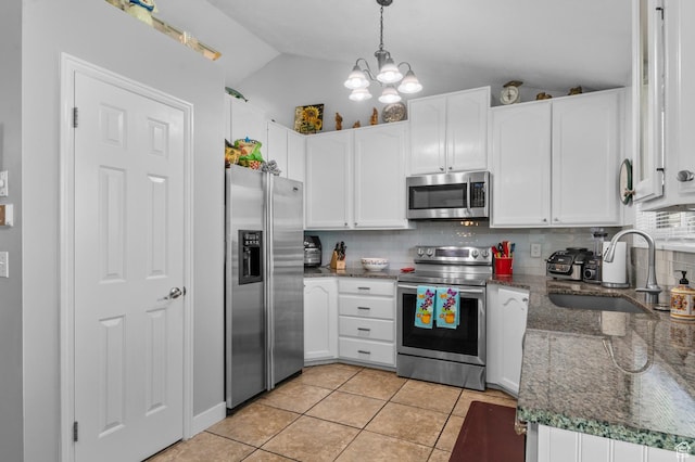 627 S 825 E, Layton, UT 84041 - kitchen featuring lofted ceiling, white cabinets, tasteful backsplash, a sink, and appliances with stainless steel finishes