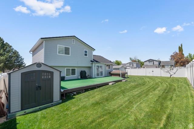 627 S 825 E, Layton, UT 84041 - back of property featuring a storage shed, a deck, a fenced backyard, an outbuilding, and a yard