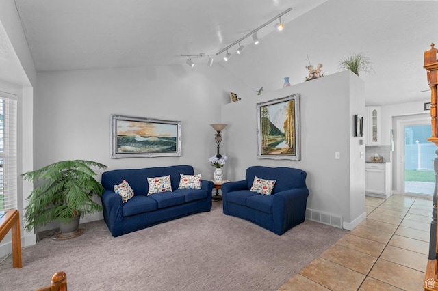 627 S 825 E, Layton, UT 84041 - living area with visible vents, light carpet, baseboards, light tile patterned floors, and vaulted ceiling