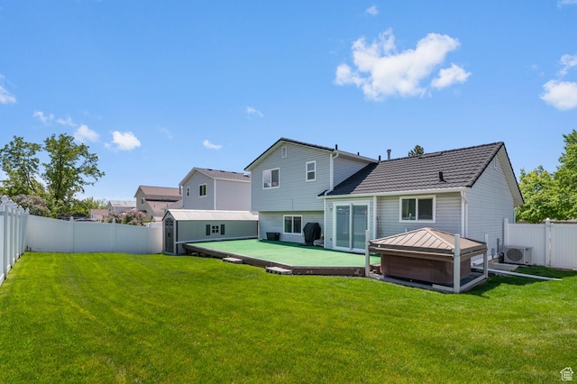 627 S 825 E, Layton, UT 84041 - rear view of house featuring a fenced backyard, a hot tub, a yard, and a storage shed