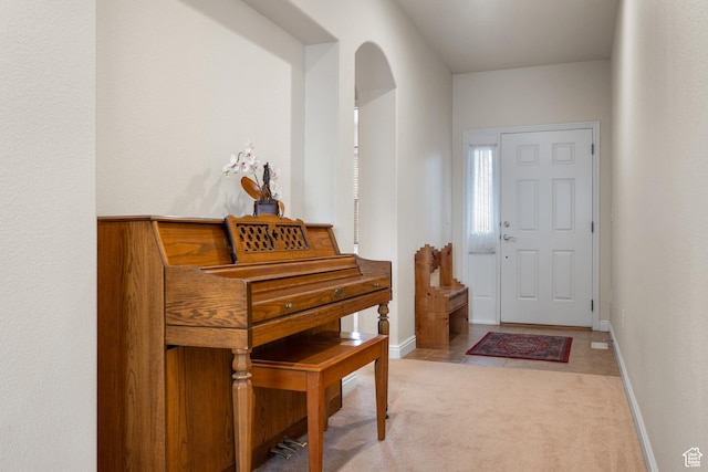 7673 N Red Oak E, Eagle Mountain, UT 84005 - entryway with baseboards, light carpet, and arched walkways