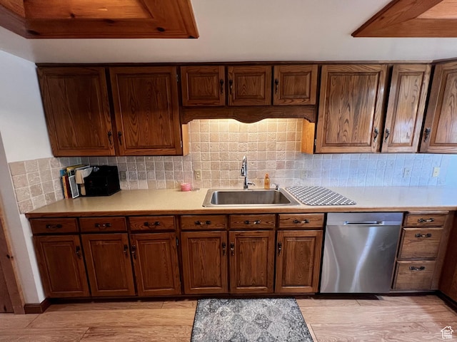 1752 Cedar View Rd, Soda Springs, ID 83276 - kitchen featuring stainless steel dishwasher, a sink, light countertops, tasteful backsplash, and light wood-style flooring
