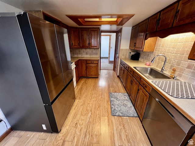 1752 Cedar View Rd, Soda Springs, ID 83276 - kitchen with appliances with stainless steel finishes, a sink, a raised ceiling, light wood-style flooring, and light countertops