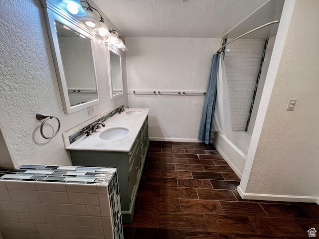 1752 Cedar View Rd, Soda Springs, ID 83276 - bathroom with a textured wall, a textured ceiling, wood tiled floors, double vanity, and baseboards
