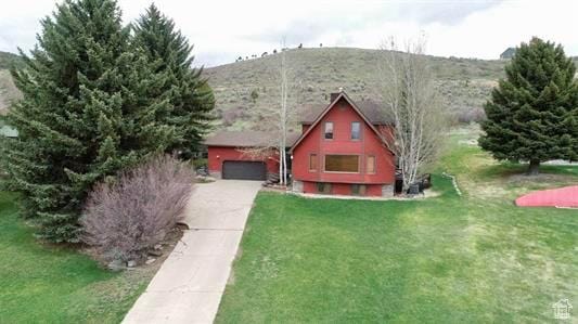 1752 Cedar View Rd, Soda Springs, ID 83276 - a-frame style home with a garage, concrete driveway, and a front lawn