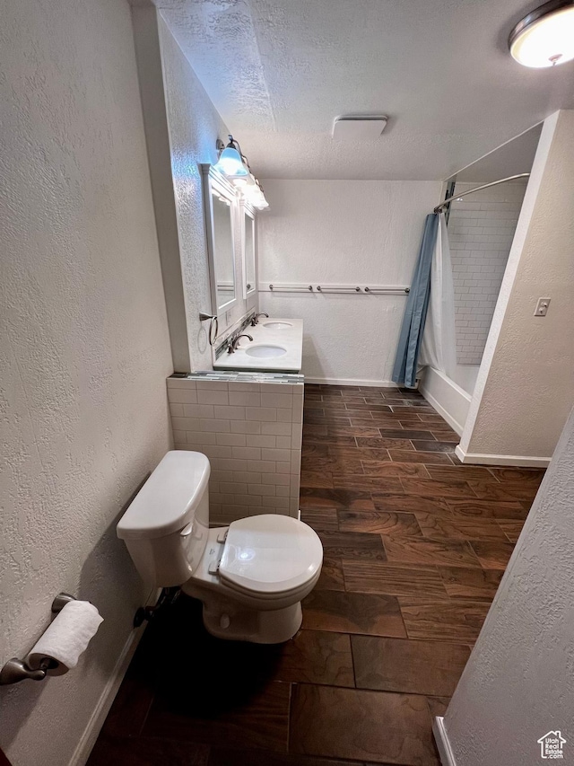 1752 Cedar View Rd, Soda Springs, ID 83276 - bathroom with toilet, a shower with curtain, wood finished floors, a textured ceiling, and a textured wall